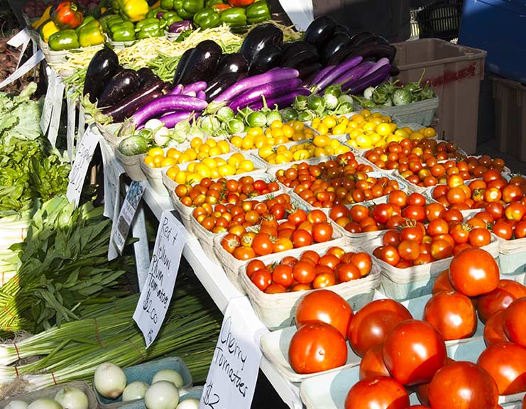 farmer's market stand with assorted vegetables